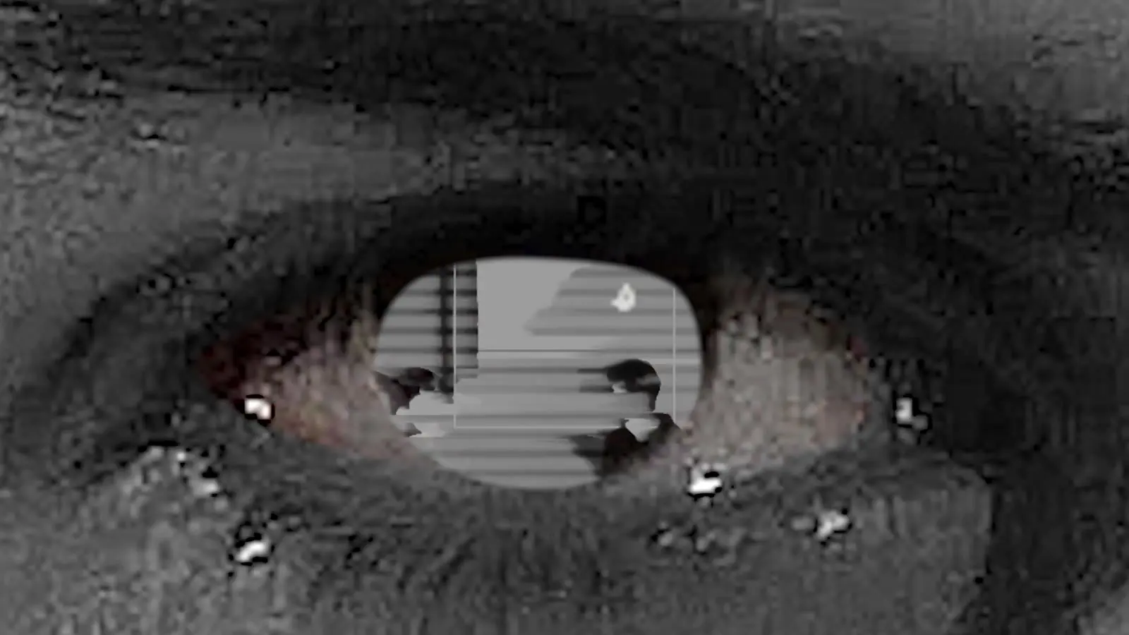 A black-and-white close-up of an eye with a glitch effect