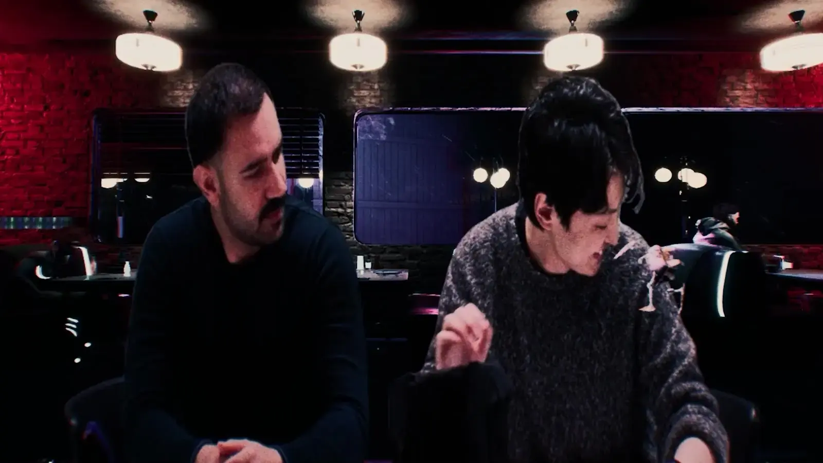 Two men talk across a table in a neon-lit diner, from Library of Babel